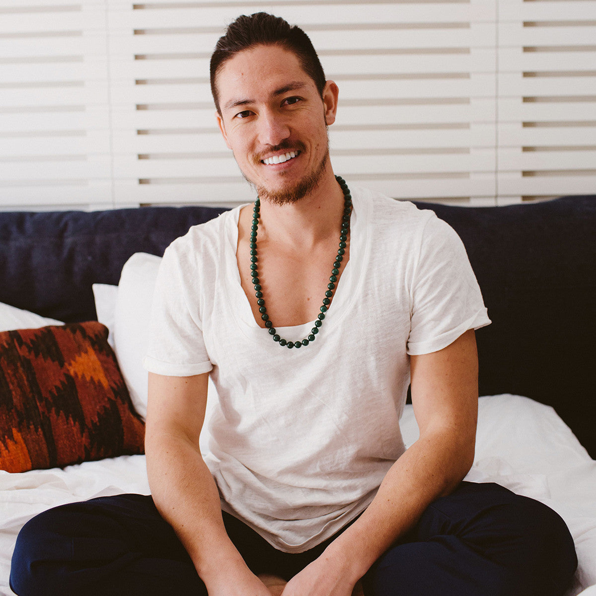A man wearing a crystal healing Dark Green Aventurine necklace known for strengthening and purifying organs