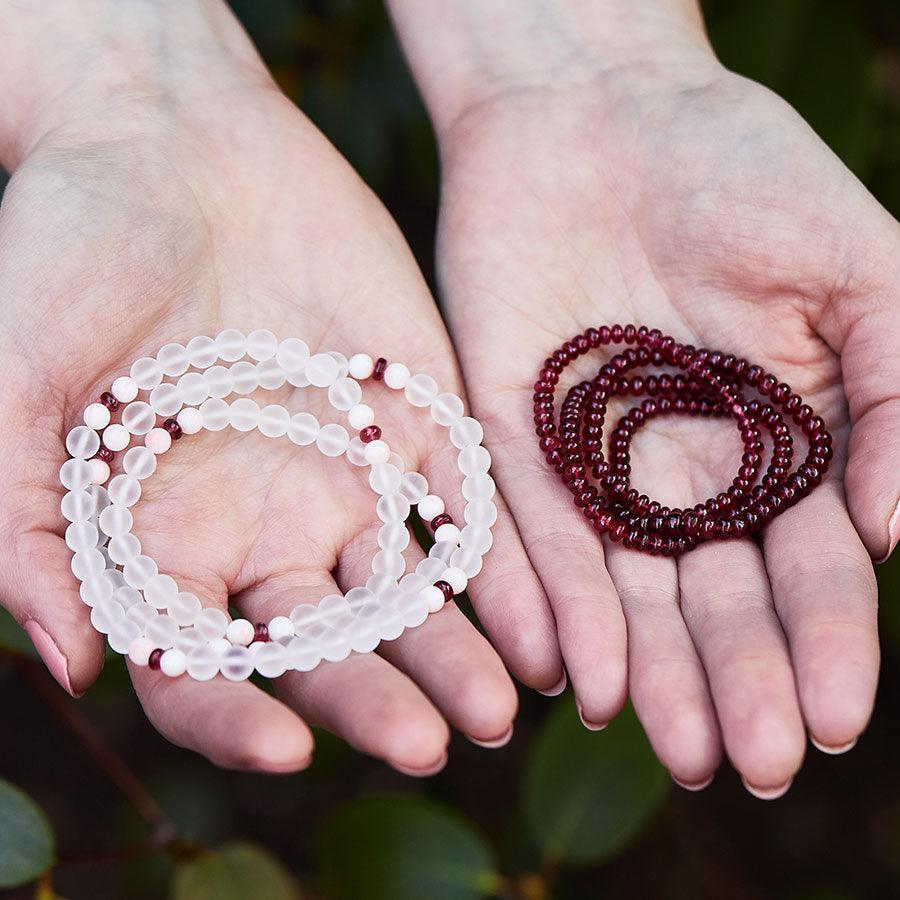 Crystal healing Dawn Light necklace known for Improving muscle strength next to a Red Spinel necklace
