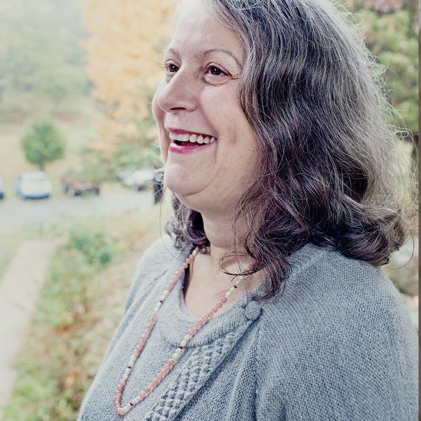 A woman wearing a crystal healing Magic Gift gemstone necklace known for raising self-esteem and confidence