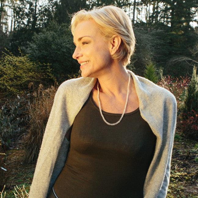 A woman wearing a crystal healing White Flash Moonstone necklace known for restoring youthfulness