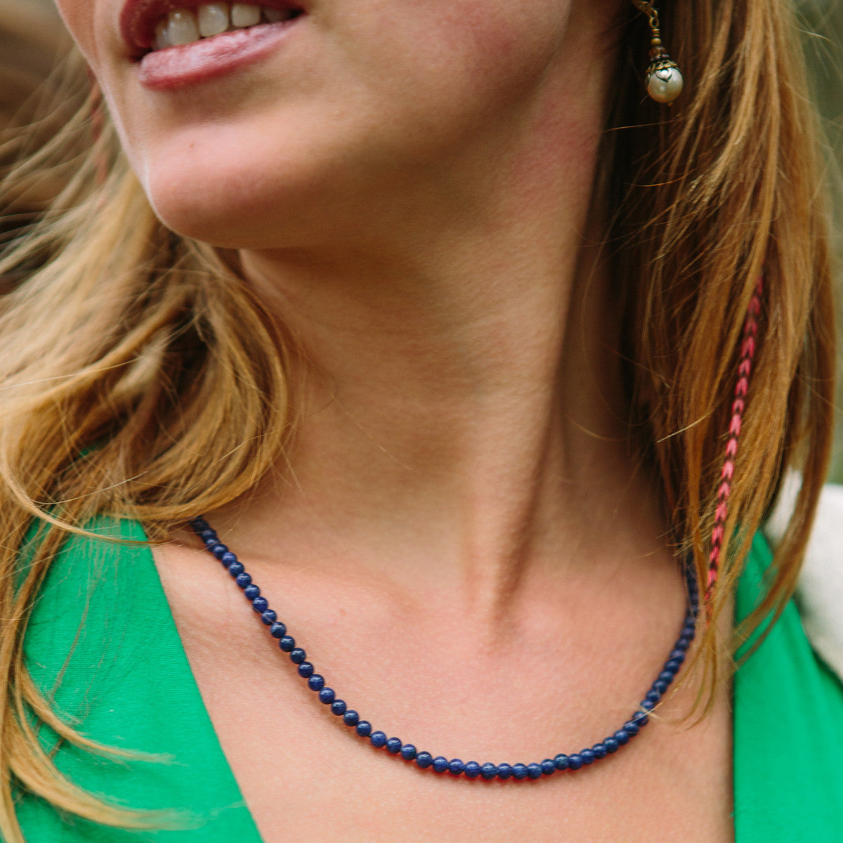 Woman wearing a crystal healing Indigo necklace known for developing and clarifying your intuition