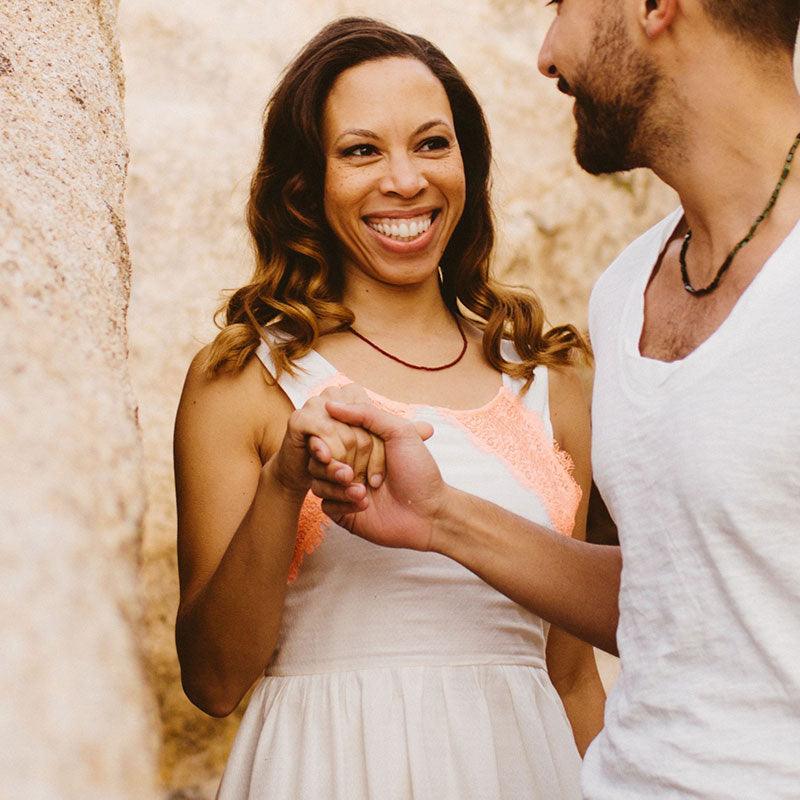 Woman wearing a crystal healing Ruby gemstone necklace known for helping heal and open your heart chakra