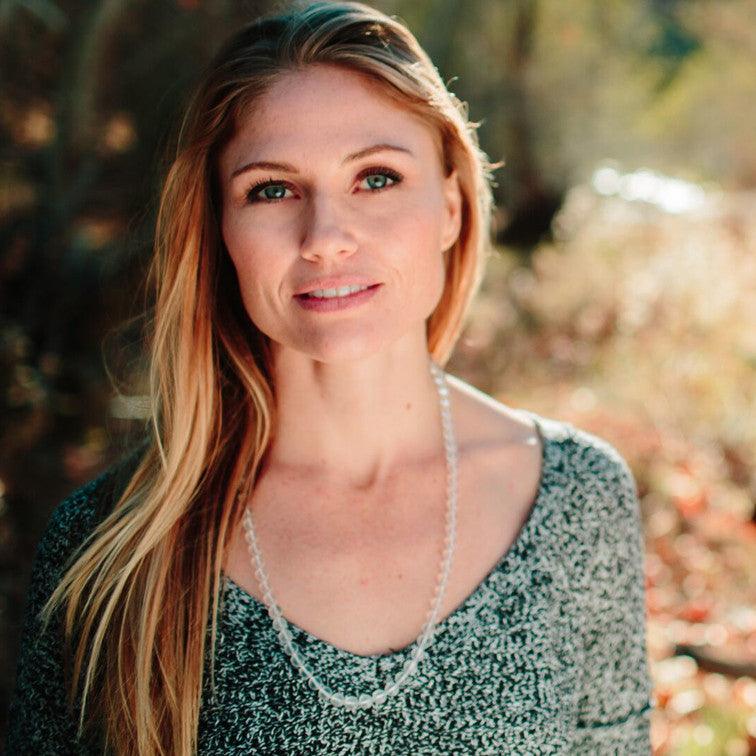 A woman wearing a crystal healing Quartz gemstone necklace known for attracting life-force