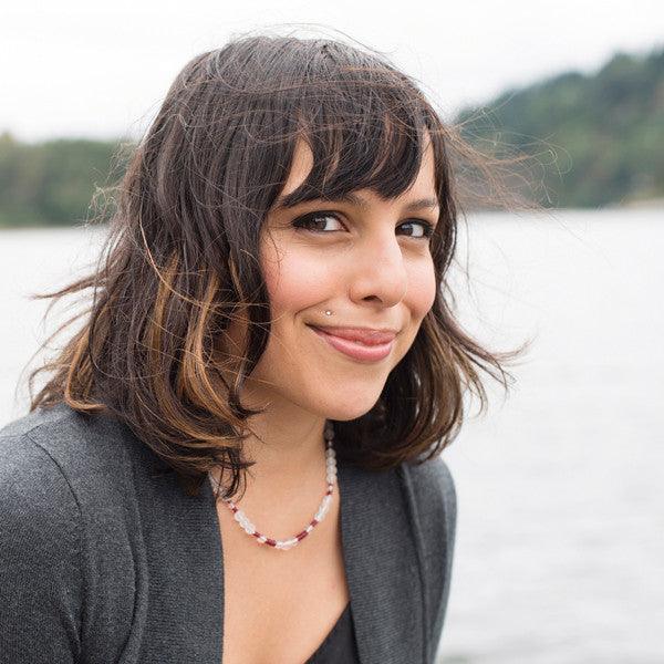 Woman wearing a crystal healing Ruby gemstone necklace known for helping heal and open your heart chakra