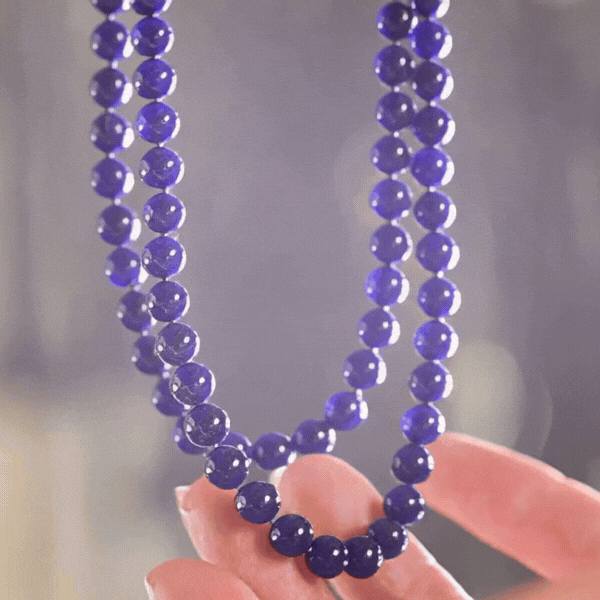Hanging, backlit Indigo. High quality Sodalight bead necklace.