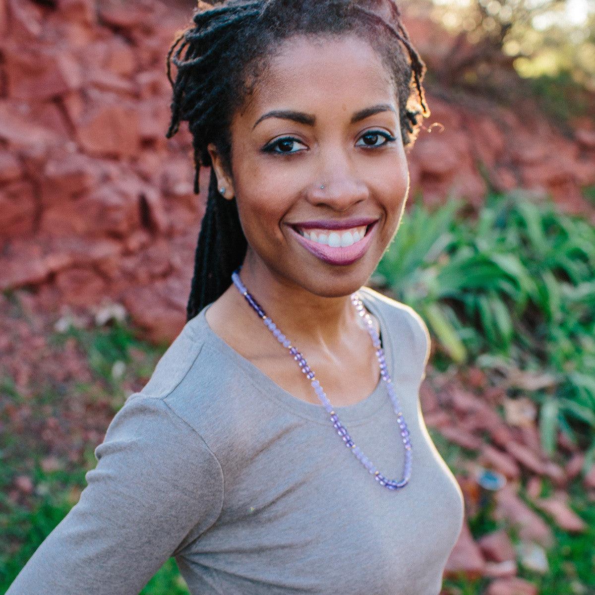 Woman wearing a crystal healing Insight necklace known for helping you understand the spiritual meaning of money