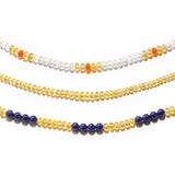 Yellow, blue, and white Golden Beryl gemstone necklaces displayed on a white table.
